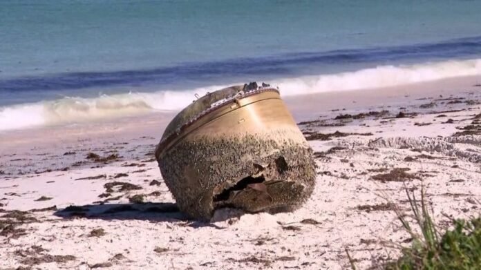 A mysterial object washes over an Australian beach.